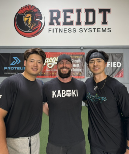 Josh Reidt with athletes inside Reidt Fitness Systems