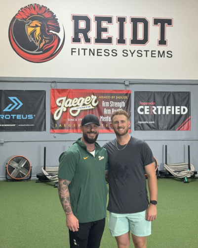 Josh Reidt with an athlete inside Reidt Fitness Systems