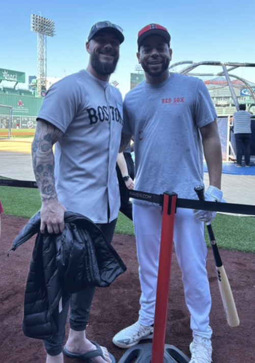 Josh Reidt with a professional baseball player at a Major League Baseball stadium