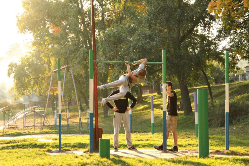 Adults using outdoor gym equipment, a common form of exercise participation in community settings