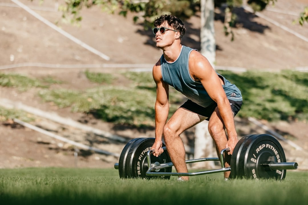 An athlete performing a heavy deadlift outdoors, the loading pattern behind questions about cardiac remodeling