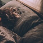 Regular exercise and restful sleep represented by a woman sleeping peacefully