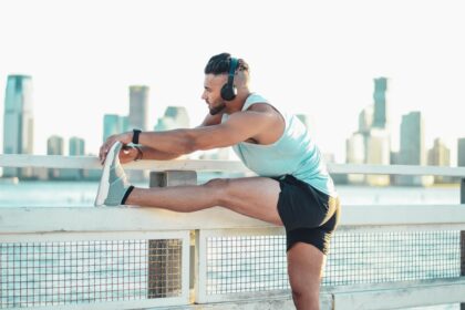 Athlete stretching a leg before running, illustrating muscle recovery after eccentric calf exercise