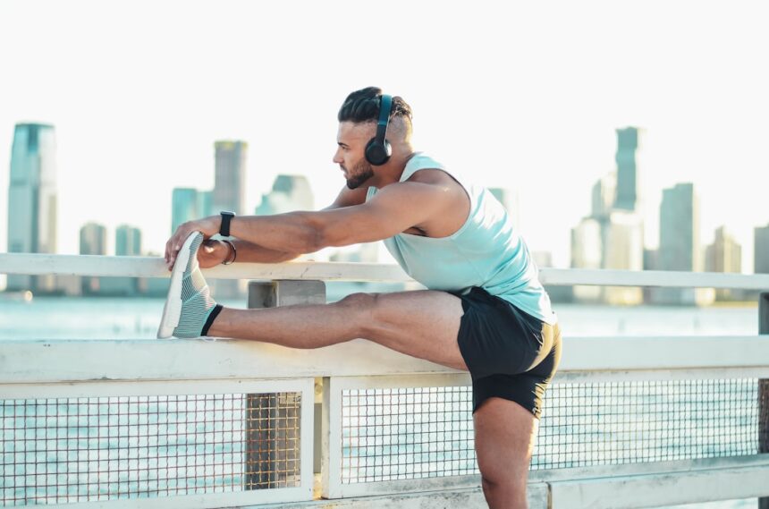 Athlete stretching a leg before running, illustrating muscle recovery after eccentric calf exercise