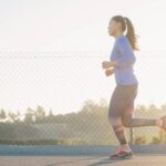 Female athlete sprinting on a track, illustrating research on caffeine and 30-meter sprint performance