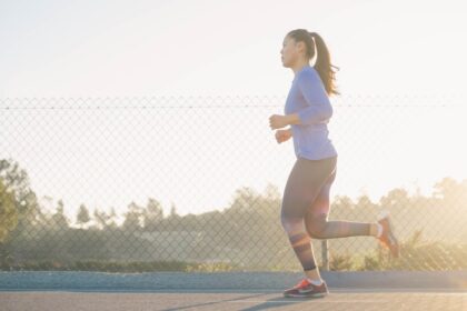 Female athlete sprinting on a track, illustrating research on caffeine and 30-meter sprint performance