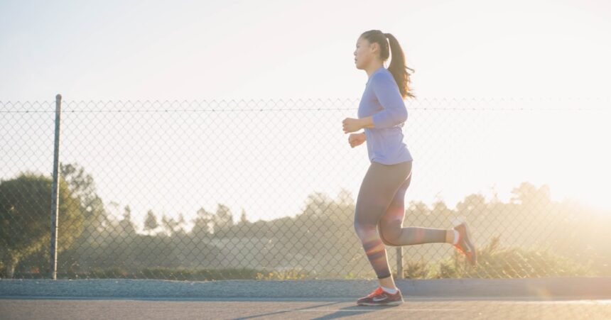 Female athlete sprinting on a track, illustrating research on caffeine and 30-meter sprint performance