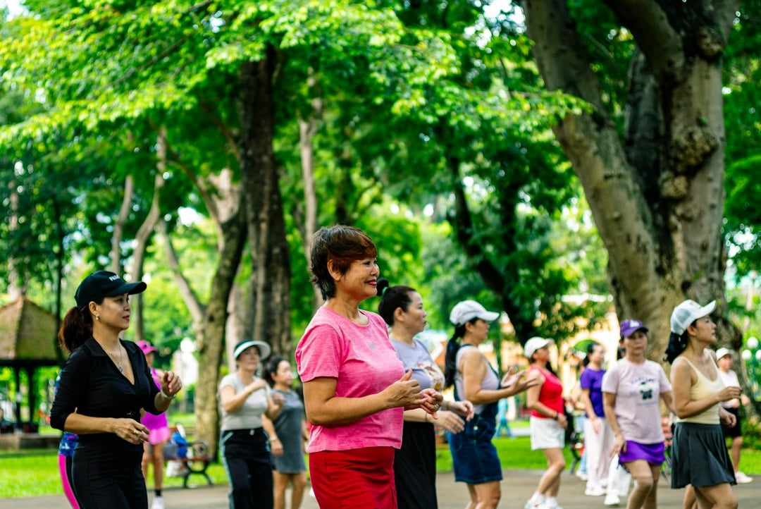 A group of women exercising in a park, reflecting the varied training studied for oxidative stress effects