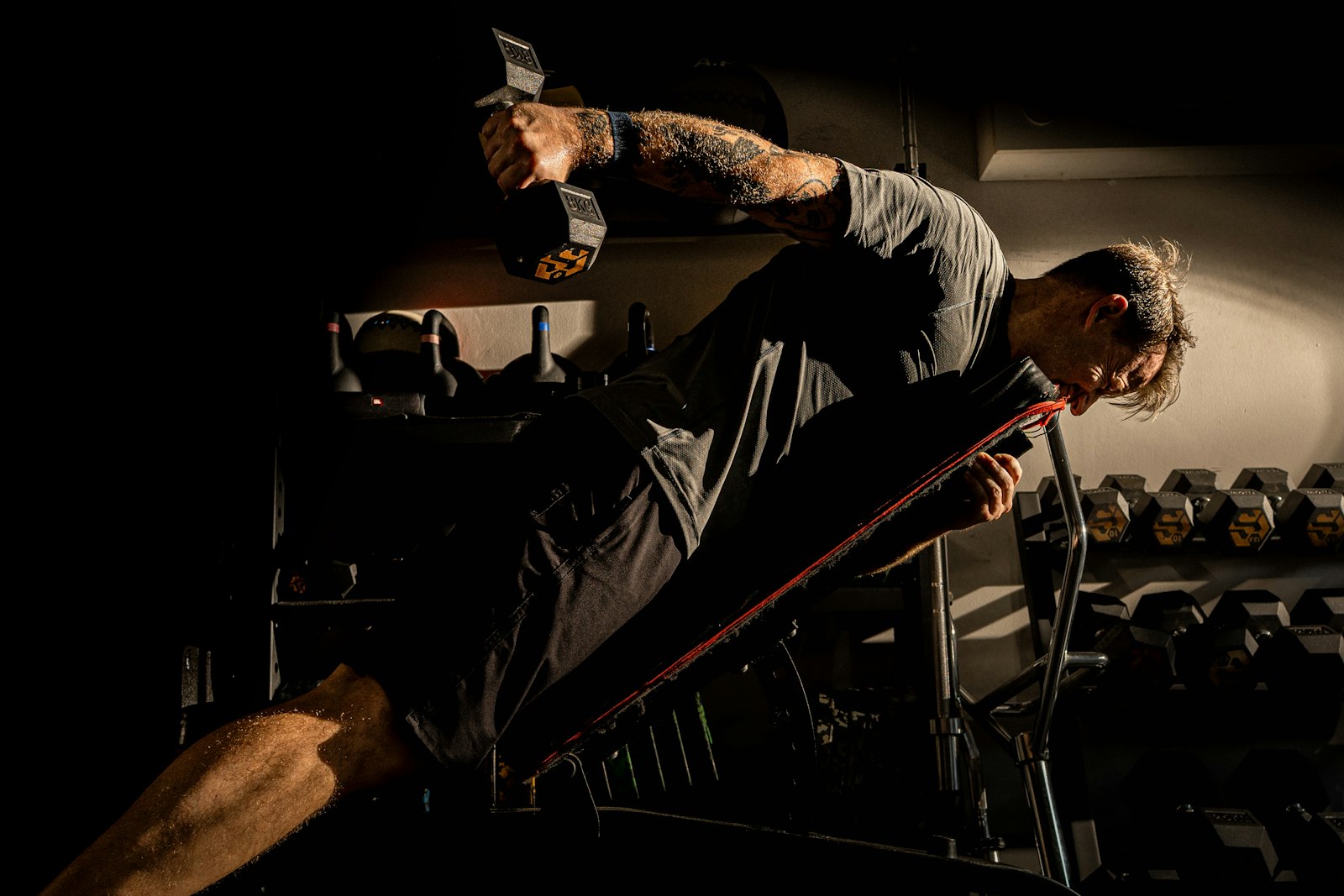 Man training with weights in a gym, illustrating research on exercise and inflammatory biomarkers