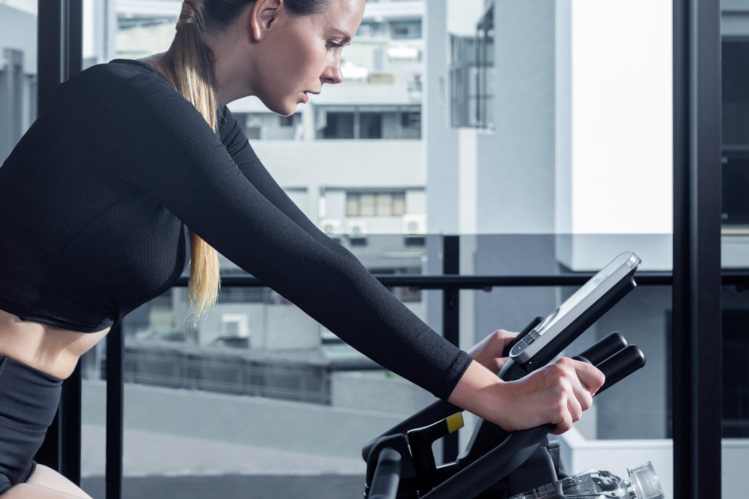 Woman exercising on a stationary bike during an indoor cycling workout