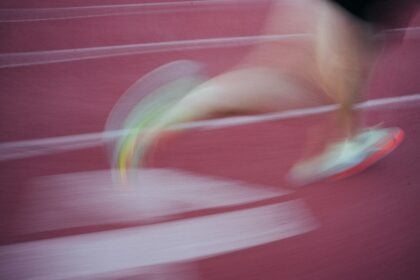 High school athlete running on a track, the sprint test used in suspension training research