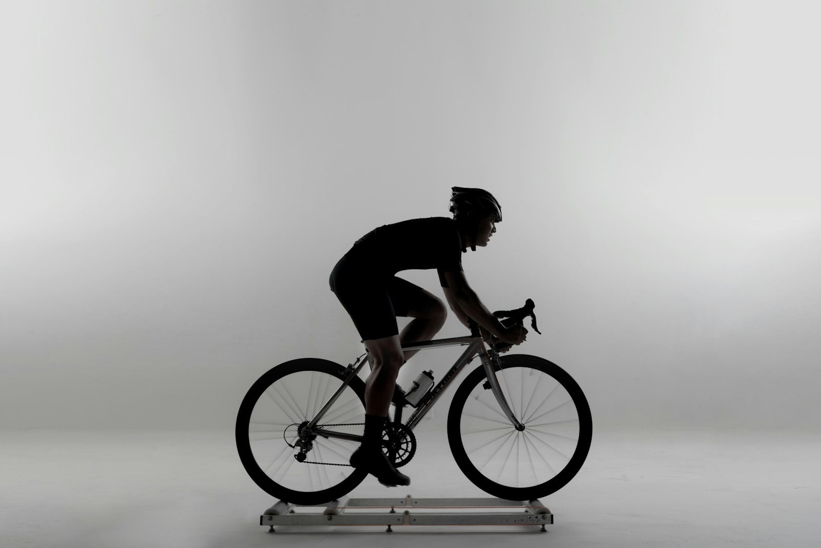 A cyclist riding on an indoor trainer, similar to the laboratory setting used to measure lactate accumulation