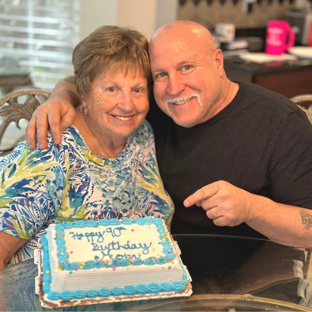 John DeFendis pictured with his mother beside a birthday cake