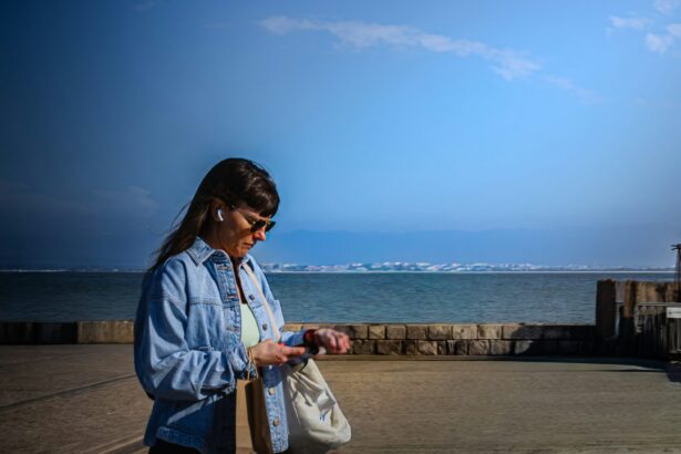 Woman checking a smartwatch during an outdoor walk, illustrating adaptive exercise prompts and wearable activity tracking