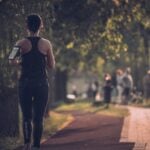 A woman walking briskly in athletic clothing, the kind of leisure activity studied in relation to cardiometabolic risk