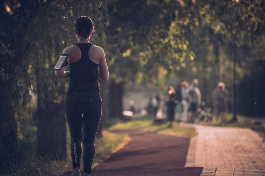 A woman walking briskly in athletic clothing, the kind of leisure activity studied in relation to cardiometabolic risk