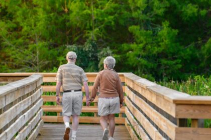 Two adults walking together outdoors during leisure-time exercise