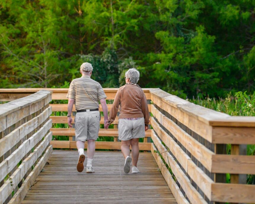 Two adults walking together outdoors during leisure-time exercise