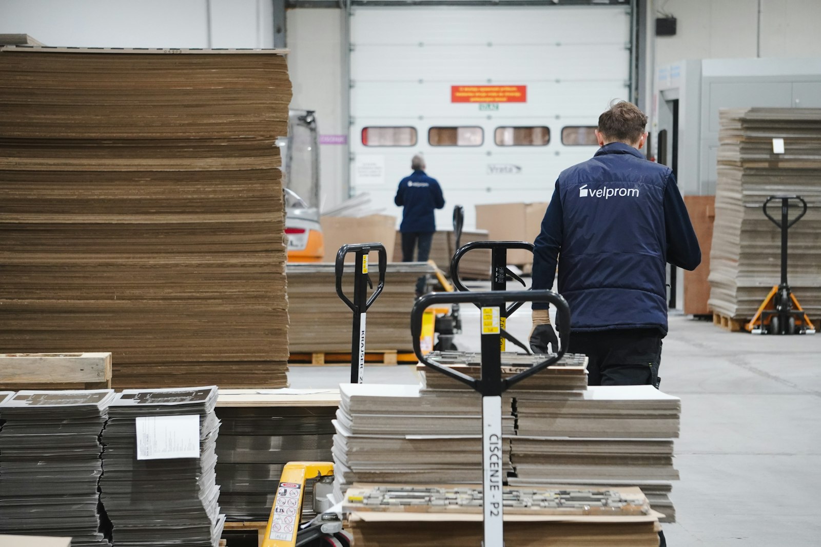 A warehouse worker moving a loaded cart, an example of occupational activity examined for cardiometabolic risk