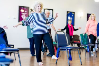 Older adults in a group exercise class, illustrating reactive balance training and mobility work