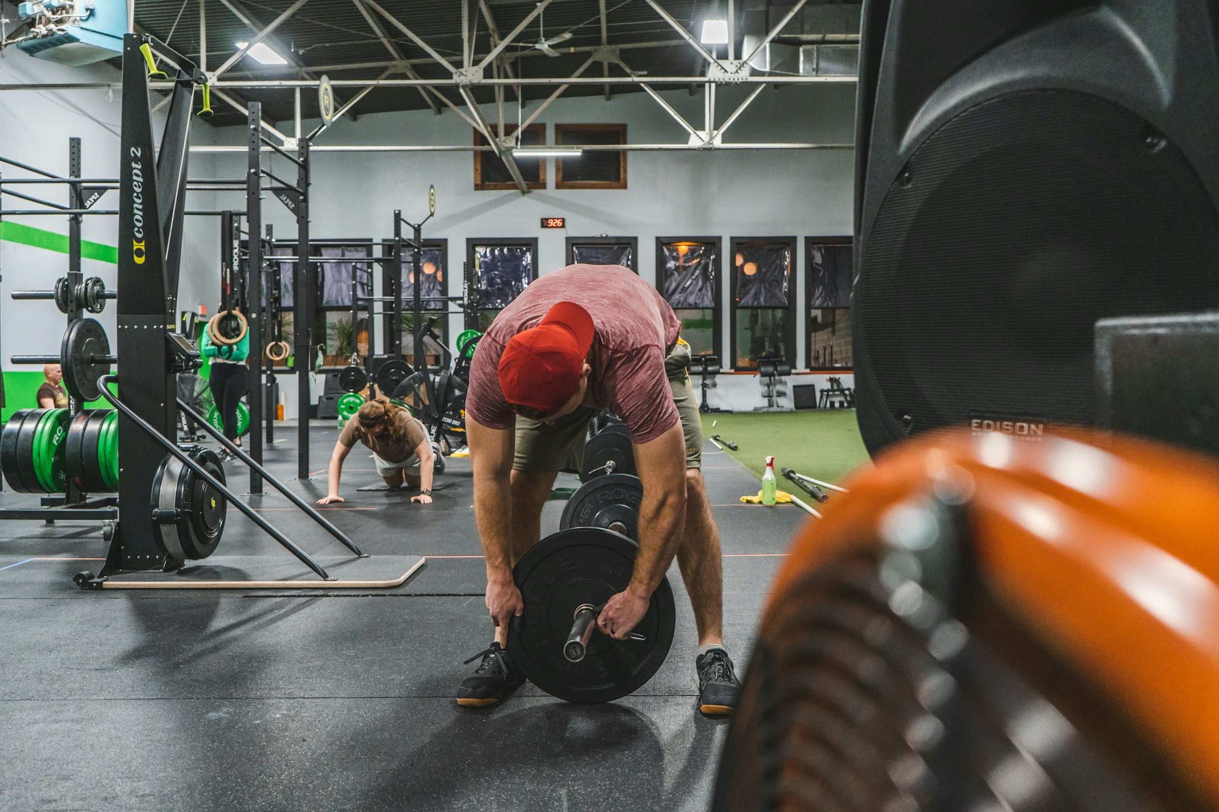 Man squatting in a strength gym, illustrating rest intervals during resistance exercise