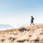 Runner on a mountain trail, illustrating hypoxic training at altitude