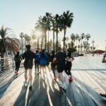 Running group doing structured exercise together at the Santa Monica Pier in California