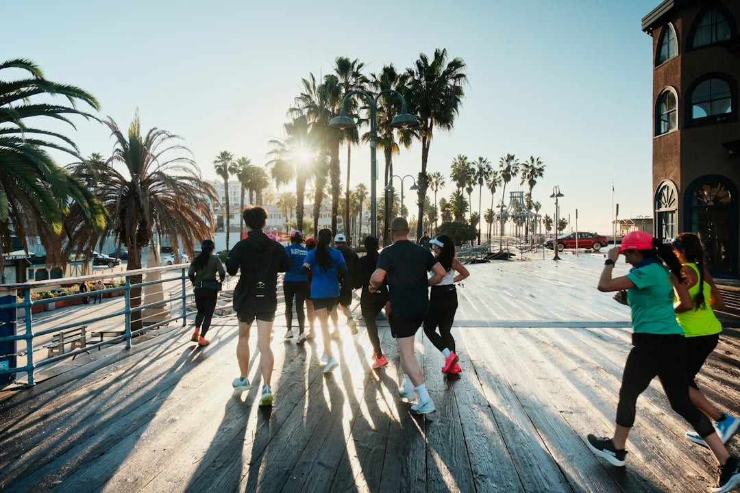 Running group doing structured exercise together at the Santa Monica Pier in California