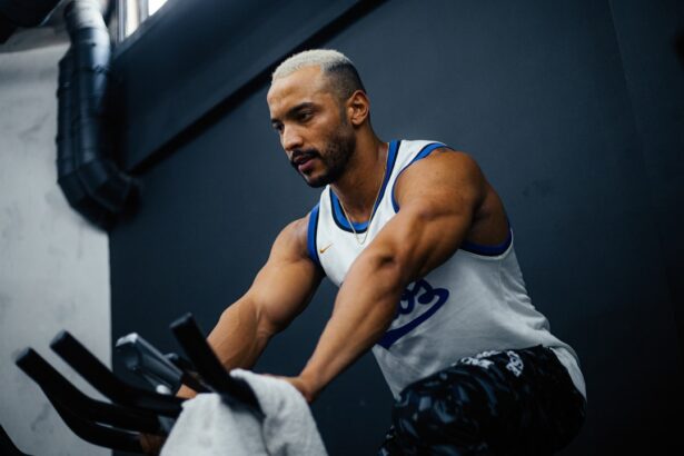 Athlete performing sprint interval exercise on a stationary bike in a gym