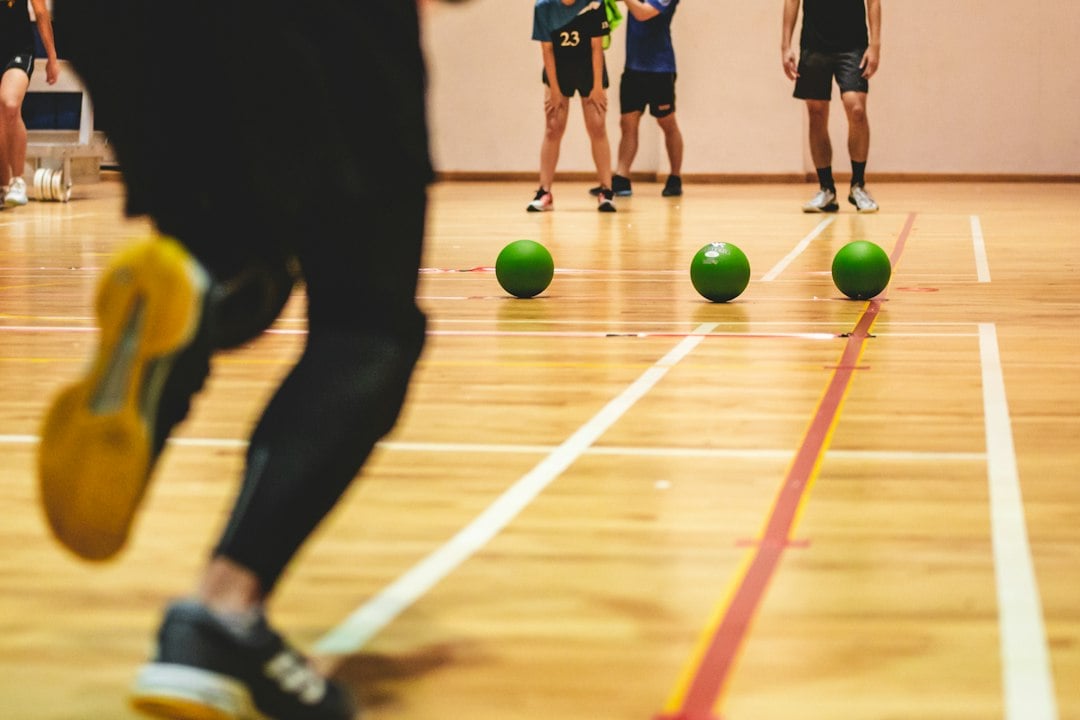 Students competing in a university sports program event in a campus sports hall