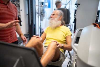 Older man exercising in a gym, illustrating supervised aerobic and resistance training during prostate cancer treatment