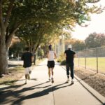 Three adults jogging outdoors, the kind of everyday activity examined in research on oxidative stress