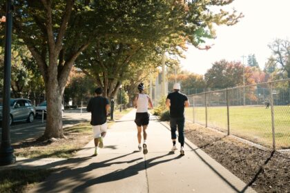 Three adults jogging outdoors, the kind of everyday activity examined in research on oxidative stress