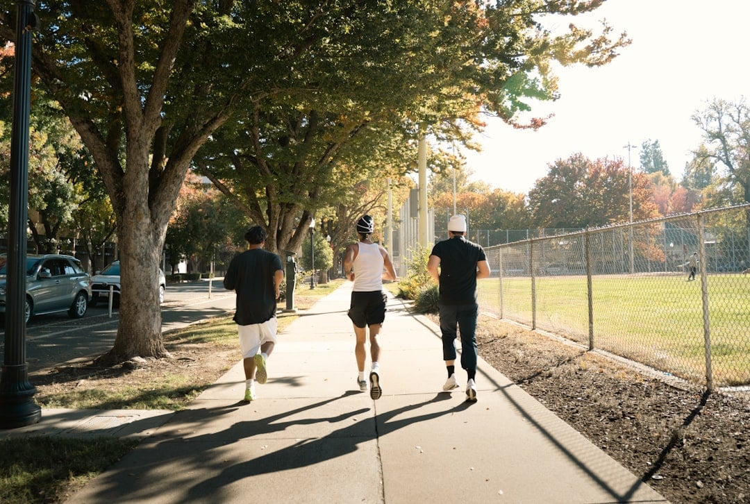 Three adults jogging outdoors, the kind of everyday activity examined in research on oxidative stress