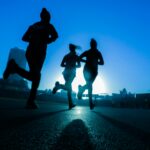 Three people running together on a road, illustrating weekend warrior exercise patterns