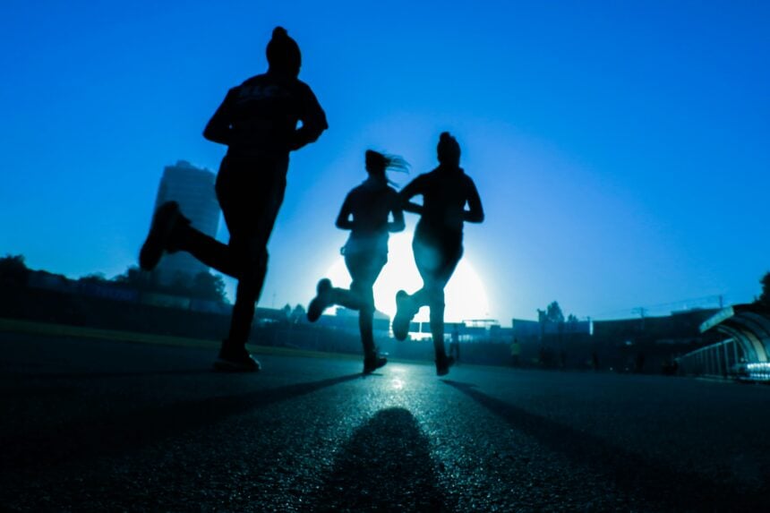 Three people running together on a road, illustrating weekend warrior exercise patterns