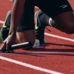 Competitive runner sprinting on an outdoor track during high-intensity training
