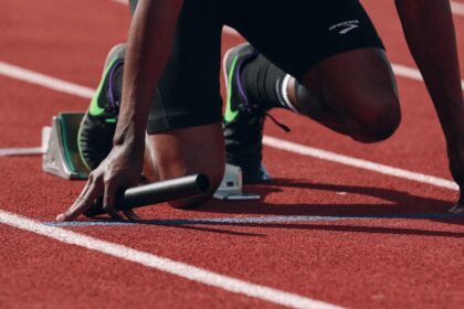 Competitive runner sprinting on an outdoor track during high-intensity training