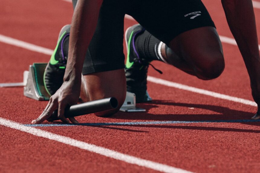 Competitive runner sprinting on an outdoor track during high-intensity training