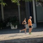 Two adults running along a street, reflecting the everyday habits behind cardiorespiratory fitness