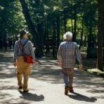 Two older adults walking outdoors, the kind of daily movement counted in the Mediterranean lifestyle index