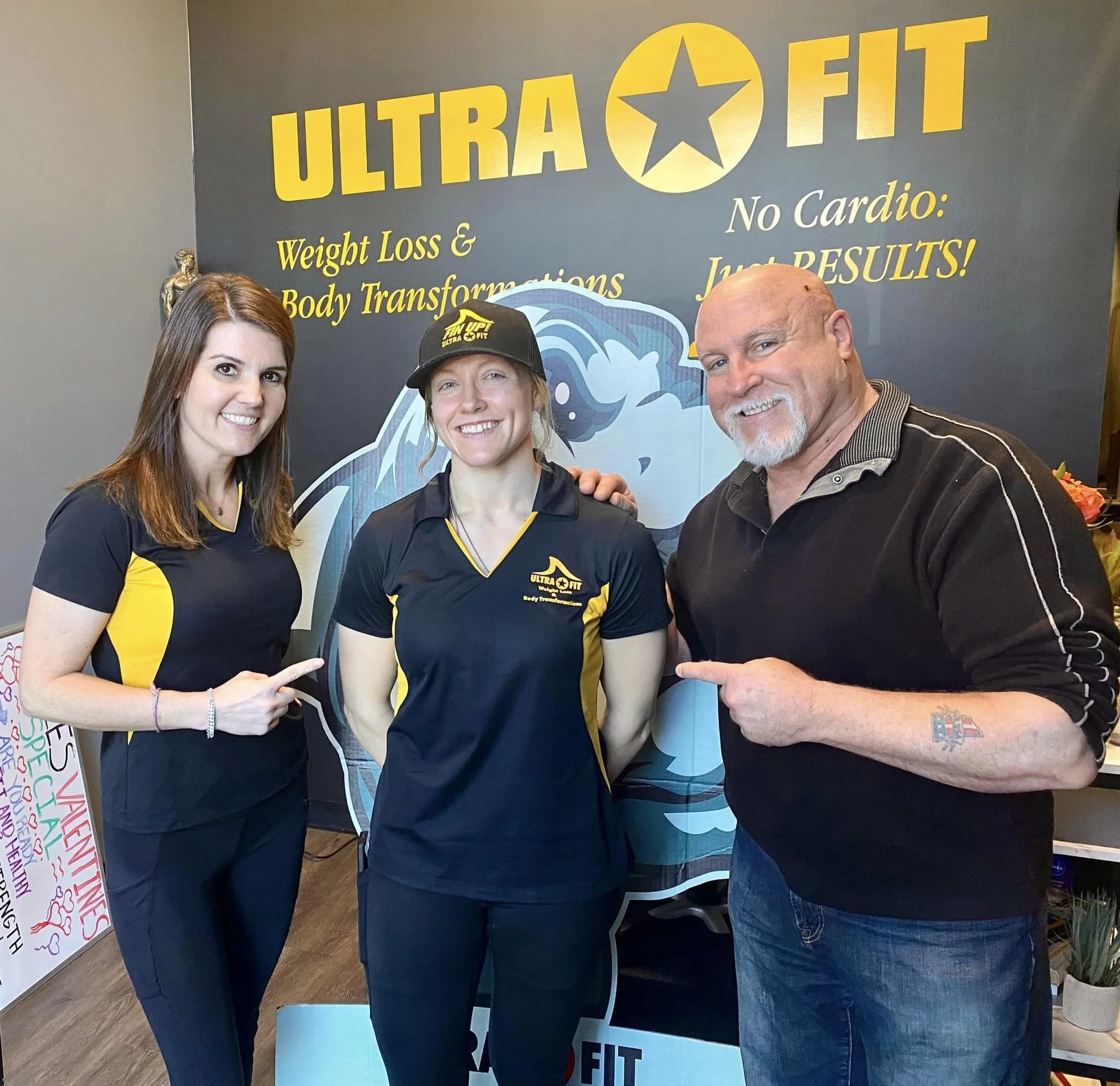 John DeFendis with Ultra Fit trainers beside an Ultra Fit display