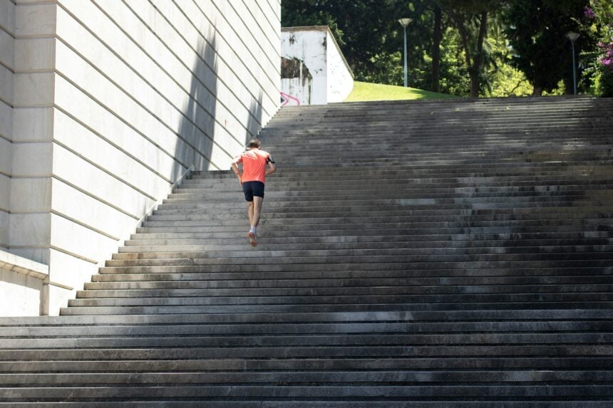 Man running up outdoor stone steps, illustrating vigorous activity and lower mortality risk