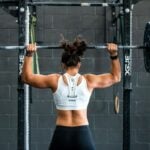 A lifter setting up under a loaded barbell, the heavy training studied for cardiac remodeling in athletes