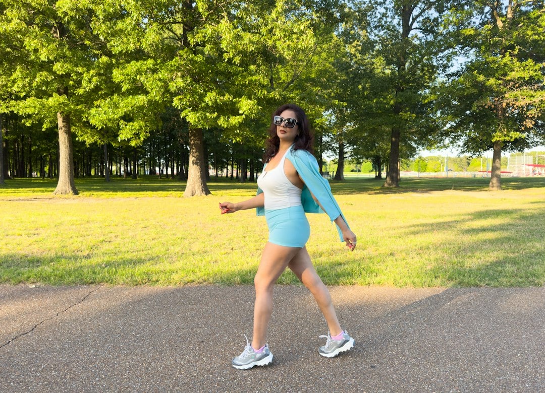 Woman jogging on a park path, a form of aerobic structured exercise