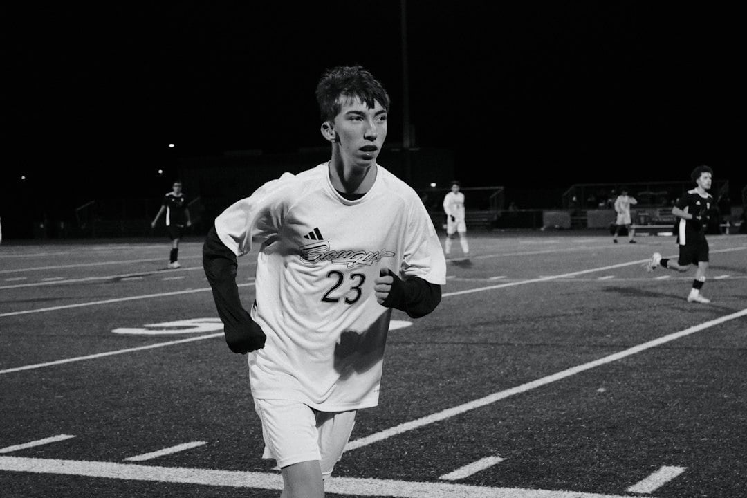 A young athlete running on a field, reflecting how physical fitness was measured in adolescents