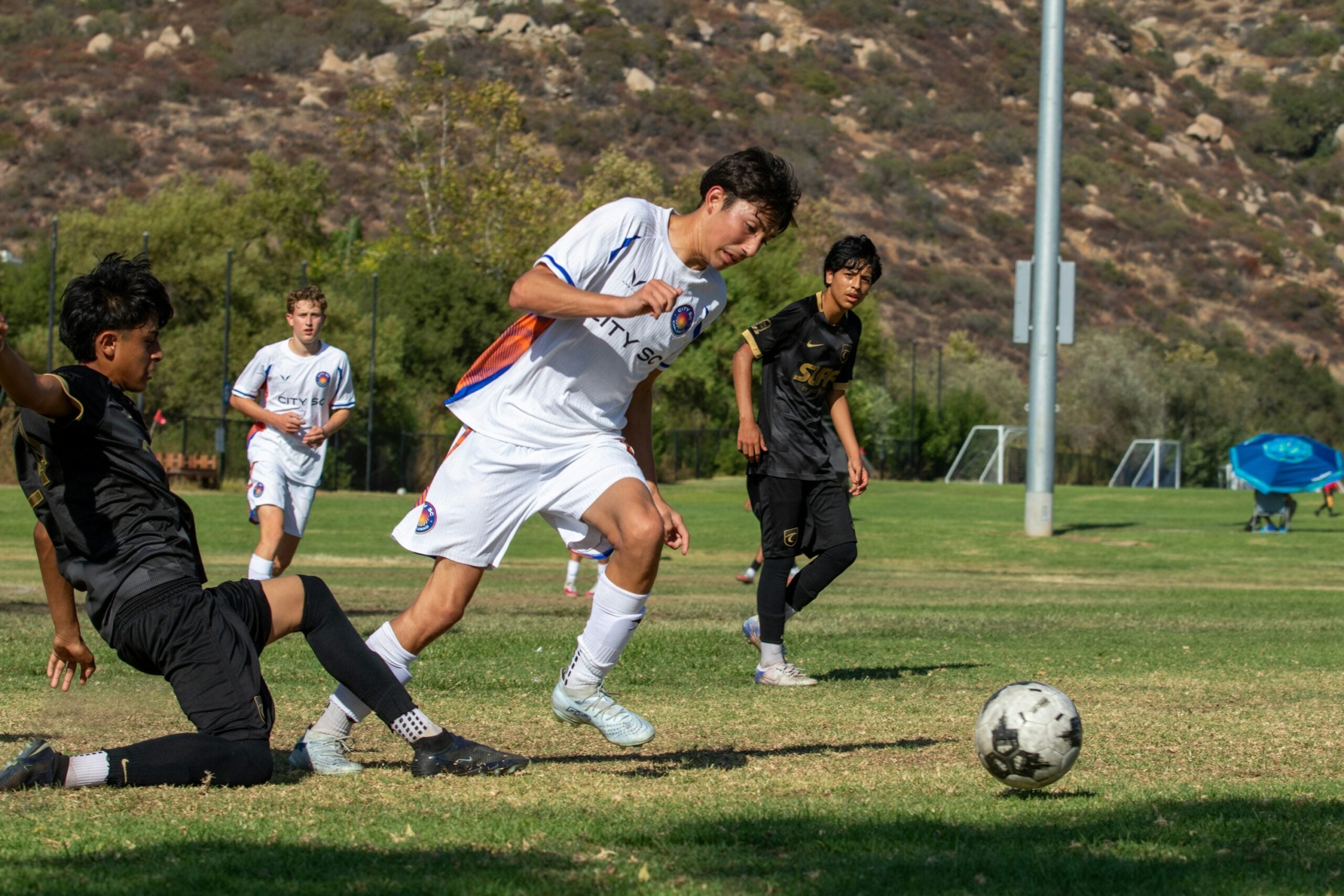 Youth soccer players competing on a training field, illustrating youth athlete development and talent selection