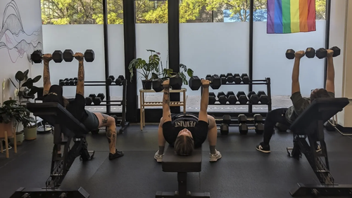 Uplift Fitness clients strength training with dumbbells in Seattle Washington