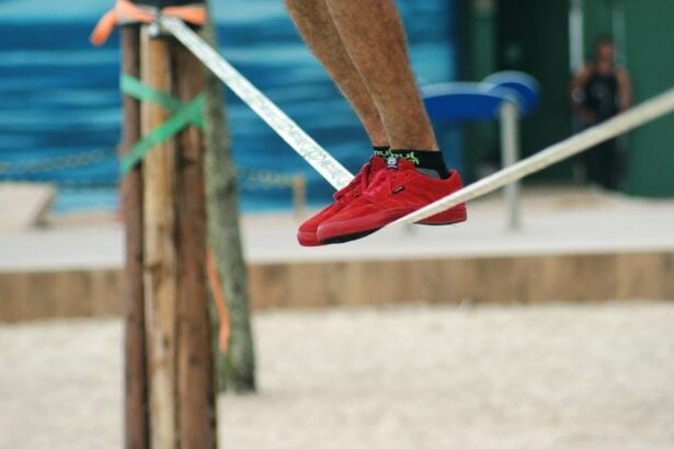 Adult balancing barefoot on webbing outdoors during a slackline training session