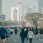 Adults running outdoors, the kind of movement wearable metrics record as steps and distance
